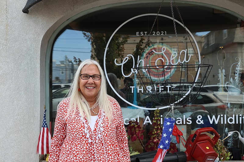 Donna Kelly stands in front of her Oh-Sea Thrift shop at 841 Central Ave.