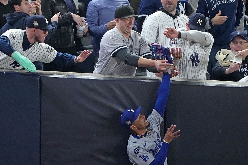 Oct 29, 2024; Bronx, New York, USA; Los Angeles Dodgers outfielder Mookie Betts (50) makes a catch in foul terriotory  against the New York Yankees in the first inning during game four of the 2024 MLB World Series at Yankee Stadium. Mandatory Credit: Robert Deutsch-Imagn Images