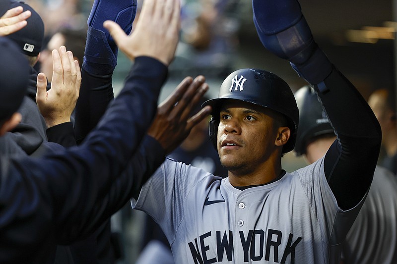 Sep 17, 2024; Seattle, Washington, USA; New York Yankees right fielder Juan Soto (22) high-fives teammates in the dugout after during the first inning at T-Mobile Park. Mandatory Credit: Joe Nicholson-Imagn Images