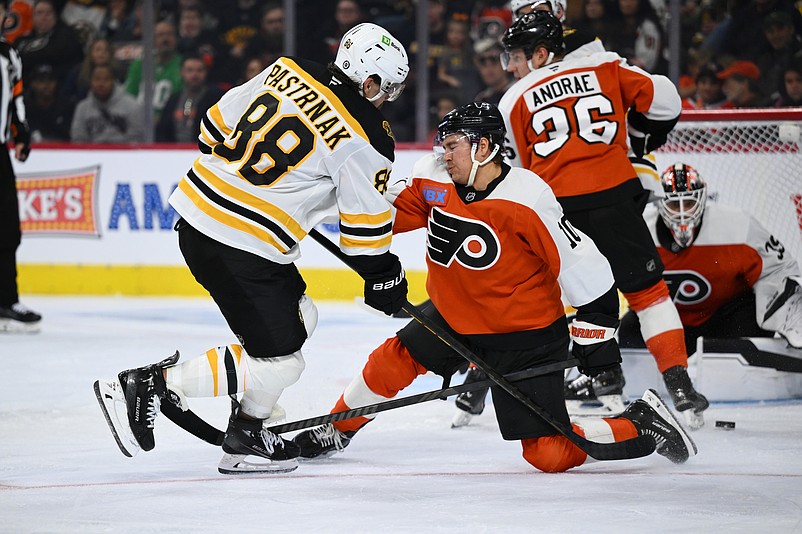 Nov 2, 2024; Philadelphia, Pennsylvania, USA; Boston Bruins right wing David Pastrnak (88) pushes the puck past Philadelphia Flyers right wing Bobby Brink (10) in the third period at Wells Fargo Center. Mandatory Credit: Kyle Ross-Imagn Images