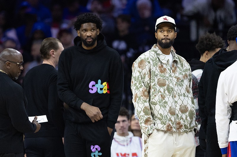 Nov 2, 2024; Philadelphia, Pennsylvania, USA; Injured Philadelphia 76ers Paul George (R) and Joel Embiid (L) look on during the first quarter against the Memphis Grizzlies at Wells Fargo Center. Mandatory Credit: Bill Streicher-Imagn Images