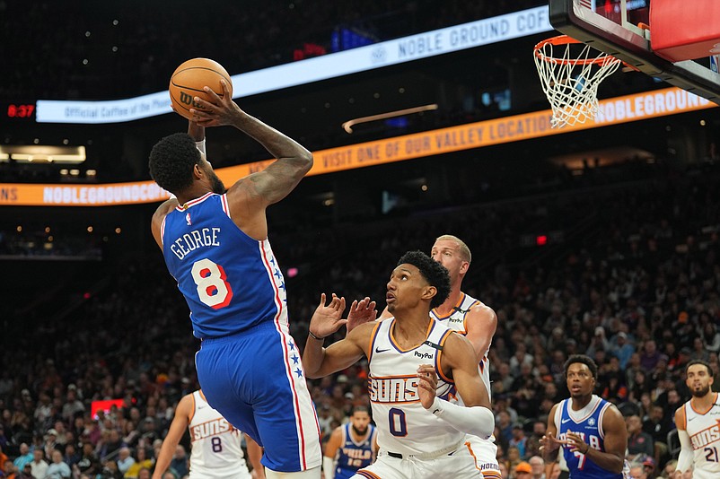 Nov 4, 2024; Phoenix, Arizona, USA; Philadelphia 76ers forward Paul George (8) shoots over Phoenix Suns forward Ryan Dunn (0) during the first half at Footprint Center. Mandatory Credit: Joe Camporeale-Imagn Images