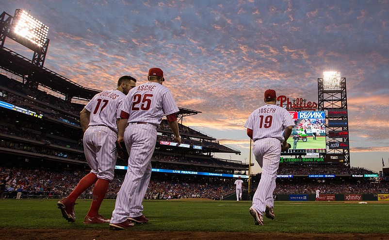 Jul 15, 2016; Philadelphia, PA, USA; Philadelphia Phillies first baseman Tommy Joseph (19) and left fielder Cody Asche (25) and right fielder Peter Bourjos (17) take the field against the New York Mets at Citizens Bank Park. The New York Mets won 5-3. Mandatory Credit: Bill Streicher-USA TODAY Sports