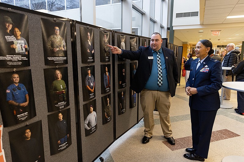 Stockton/Michael Barany, director of Stockton’s Military and Veteran Success Center, shows last year’s Military Community Photograph Project to Col. Yvonne L. Mays, 177th Fighter Wing, New Jersey Air National Guard after Stockton’s 2023 Veterans Day Recognition Ceremony.