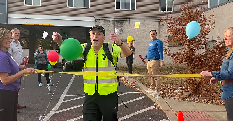 Reid crosses the finish line of his 23-mile trek at 5 p.m. Oct. 30. (Credit: North Penn YMCA)