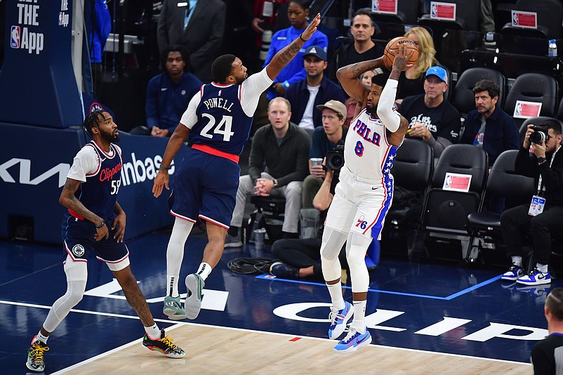 Nov 6, 2024; Inglewood, California, USA; Philadelphia 76ers forward Paul George (8) passes the ball against Los Angeles Clippers guard Norman Powell (24) during the first half at Intuit Dome. Mandatory Credit: Gary A. Vasquez-Imagn Images