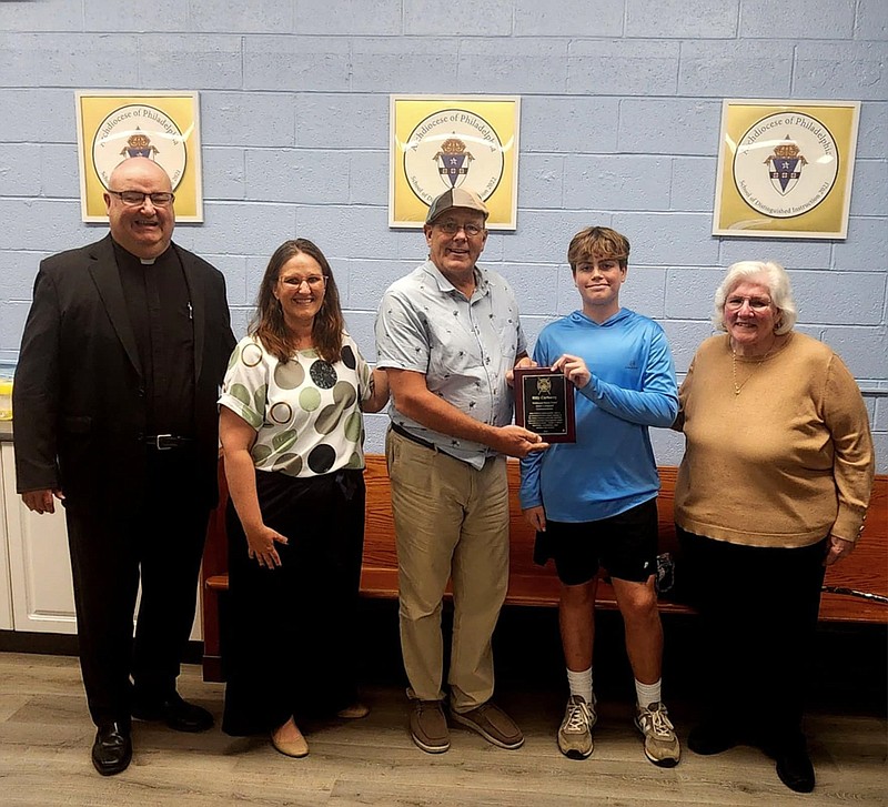 Billy Carberry receives his award from Wildwood Beach Patrol Captain Ed Schneider. Also pictured, from left, are Our Lady of Calvary School Rev. John Babowitch, Assistant Principal Sheila Picinich and Principal Jeanne Costello. (Courtesy of Ed Schneider)