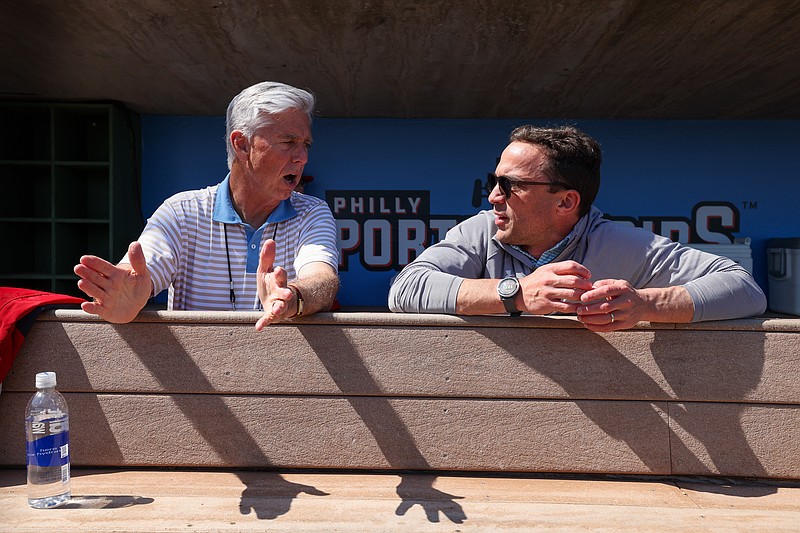 Feb 25, 2024; Clearwater, Florida, USA;  Philadelphia Phillies president of baseball operations Dave Dombrowski and general manager Sam Fuld talk in the dugout before a game against the New York Yankees at BayCare Ballpark. Mandatory Credit: Nathan Ray Seebeck-USA TODAY Sports