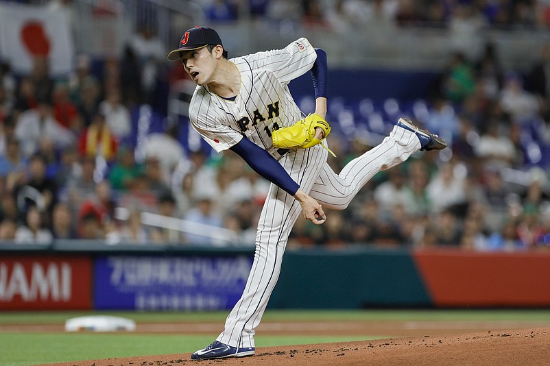 Mar 20, 2023; Miami, Florida, USA; Japan starting pitcher Roki Sasaki (14) delivers a pitch during the first inning against Mexico at LoanDepot Park. Mandatory Credit: Sam Navarro-USA TODAY Sports