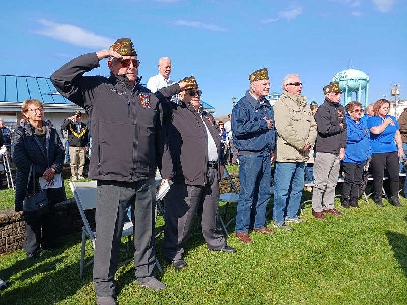 Veterans salute and place their hands over their hearts during the playing of the national anthem at Sea Isle's 2023 Veterans Day ceremony.