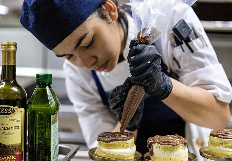 Students at the Academy of Culinary Arts decorate desserts for the Chaine de Rotisseurs dinner.