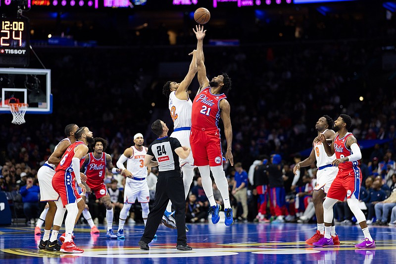 Nov 12, 2024; Philadelphia, Pennsylvania, USA; Philadelphia 76ers center Joel Embiid (21) and New York Knicks center Karl-Anthony Towns (32) tip off to start the game at Wells Fargo Center. Mandatory Credit: Bill Streicher-Imagn Images