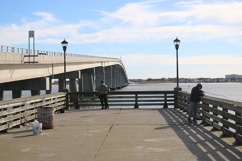 The fishing pier is next to the Ocean City-Longport Bridge to the left.