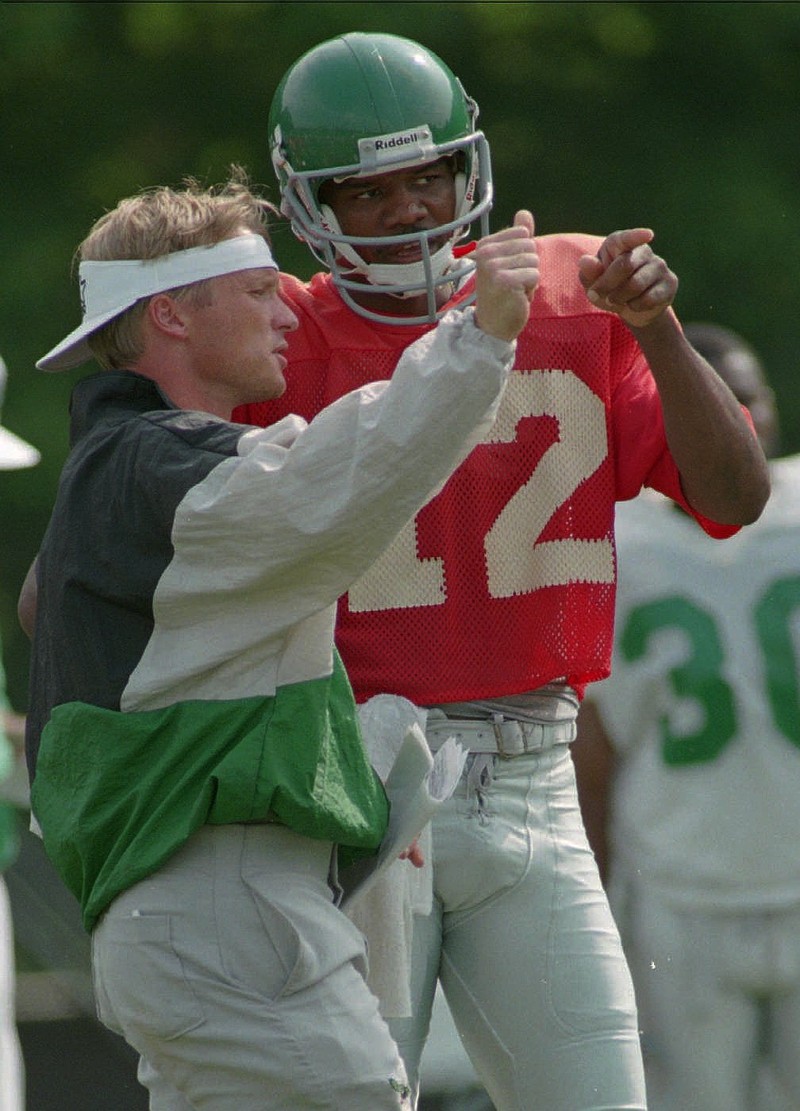 Philadelphia Eagles QB Randall Cunningham and offensive coordinator Jon Gruden talk strategy during training camp on July 26, 1995...Eagles Training Camp S Fbn Usa Pa