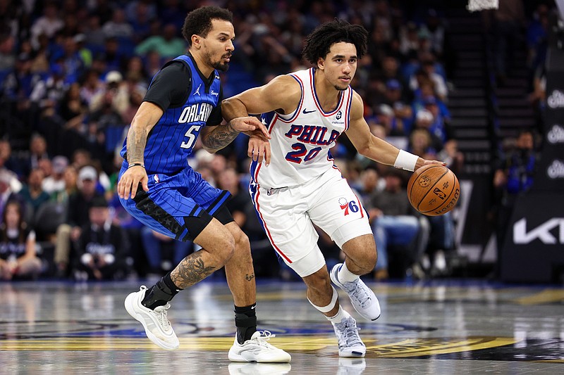 Nov 15, 2024; Orlando, Florida, USA; Philadelphia 76ers guard Jared McCain (20) drives to the basket past Orlando Magic guard Cole Anthony (50) in the second quarter at Kia Center. Mandatory Credit: Nathan Ray Seebeck-Imagn Images