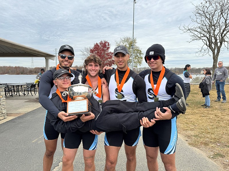 Stockton/From left, Angel Pena-Alvarez, Liam Deibert, Joe Wagner and Vincenzo Mauceri hold coxswain Justin Ferrell after the Stockton University Varsity 4 boat won the gold medal at the Bill Braxton Memorial Regatta on Sunday, Nov. 10.