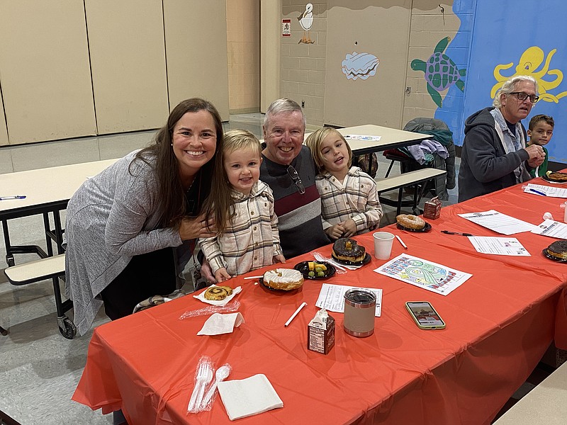 Ocean City Primary School reading specialist Jamie Nicholl and her two sons, Reed and Leo, sit with their father/grandfather, Michael Callahan, during the "Pastries with Patriots" event. (Photo courtesy of Ocean City School District)