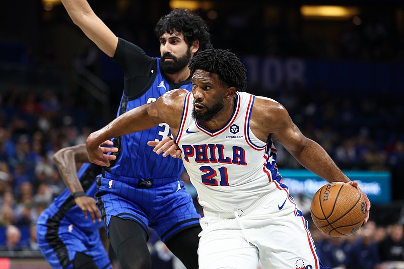 Nov 15, 2024; Orlando, Florida, USA; Philadelphia 76ers center Joel Embiid (21) drives to the basket past Orlando Magic center Goga Bitadze (35) in the first quarter at Kia Center. Mandatory Credit: Nathan Ray Seebeck-Imagn Images