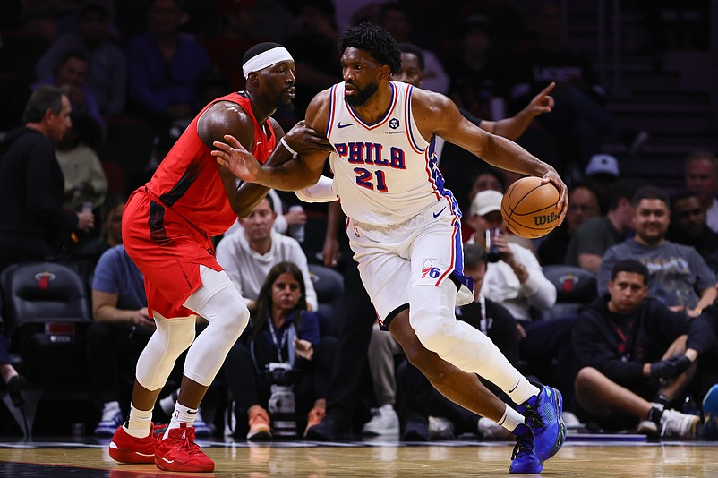 Nov 18, 2024; Miami, Florida, USA; Philadelphia 76ers center Joel Embiid (21) drives to the basket against Miami Heat center Bam Adebayo (13) during the first quarter at Kaseya Center. Mandatory Credit: Sam Navarro-Imagn Images