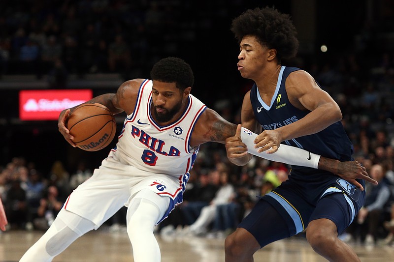 Nov 20, 2024; Memphis, Tennessee, USA; Philadelphia 76ers forward Paul George (8) drives to the basket as Memphis Grizzlies forward Jaylen Wells (0) defends during the first half at FedExForum. Mandatory Credit: Petre Thomas-Imagn Images