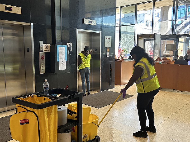 Employees with Atlantic City Public Works' Building Maintenance Division clean City Hall's lobby.