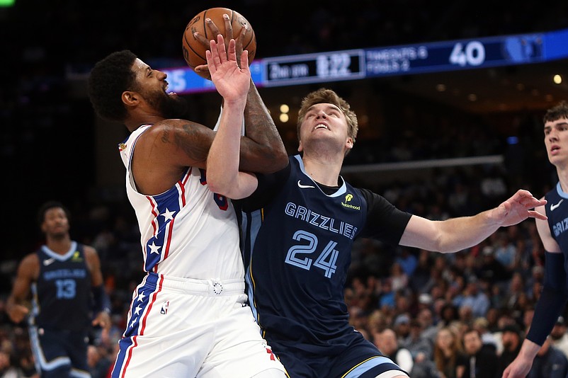 Nov 20, 2024; Memphis, Tennessee, USA; Philadelphia 76ers forward Paul George (8) drives to the basket as Memphis Grizzlies guard Cam Spencer (24) defends during the first half at FedExForum. Mandatory Credit: Petre Thomas-Imagn Images