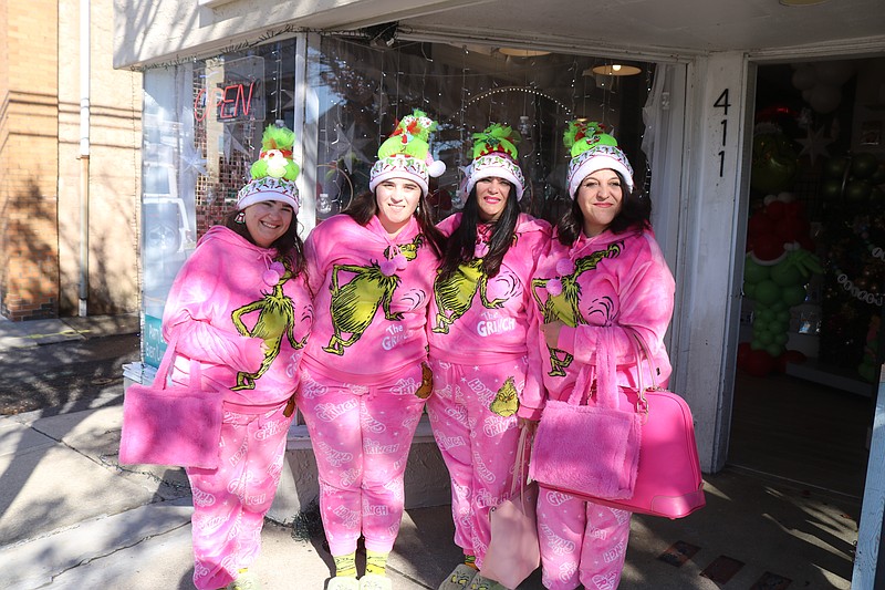 From left, Tia Riendeau, Rachel Riendeau, Teresa Riendeau and Nicole Caputo show off their gaudy pink pajamas while hitting the downtown shops.