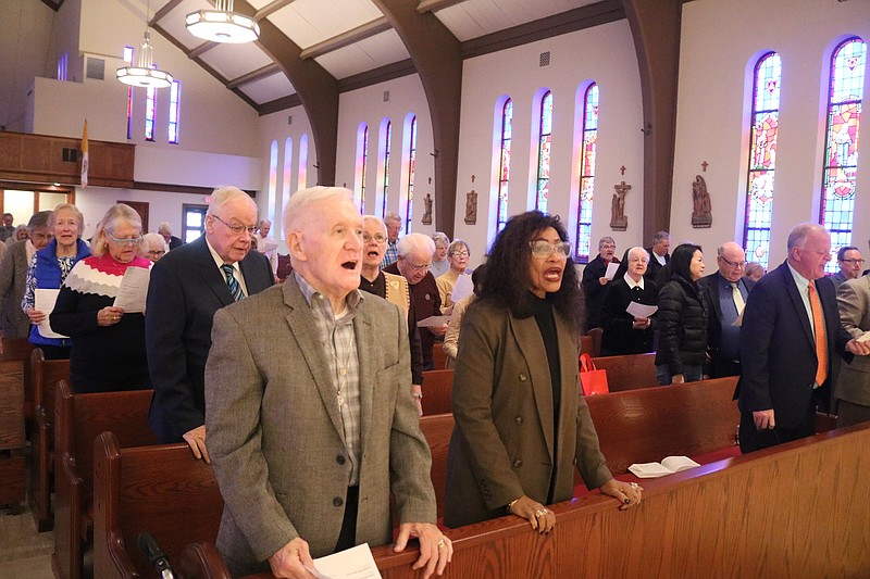 Worshippers and clergy members sing a hymn during the Thanksgiving community service at St. Frances Cabrini Church.