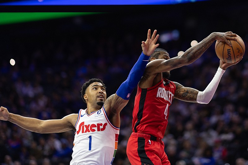 Nov 27, 2024; Philadelphia, Pennsylvania, USA; Houston Rockets guard Jalen Green (4) rebounds the ball past Philadelphia 76ers forward KJ Martin (1) during the second quarter at Wells Fargo Center. Mandatory Credit: Bill Streicher-Imagn Images