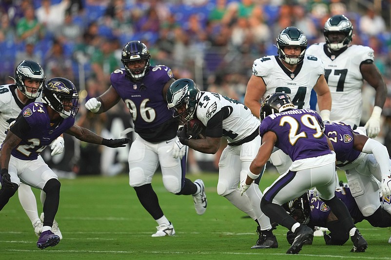 Aug 9, 2024; Baltimore, Maryland, USA; Philadelphia Eagles running back Kenneth Gainwell (14) picks up yards in the first quarter against the Baltimore Ravens at M&T Bank Stadium. Mandatory Credit: Mitch Stringer-USA TODAY Sports