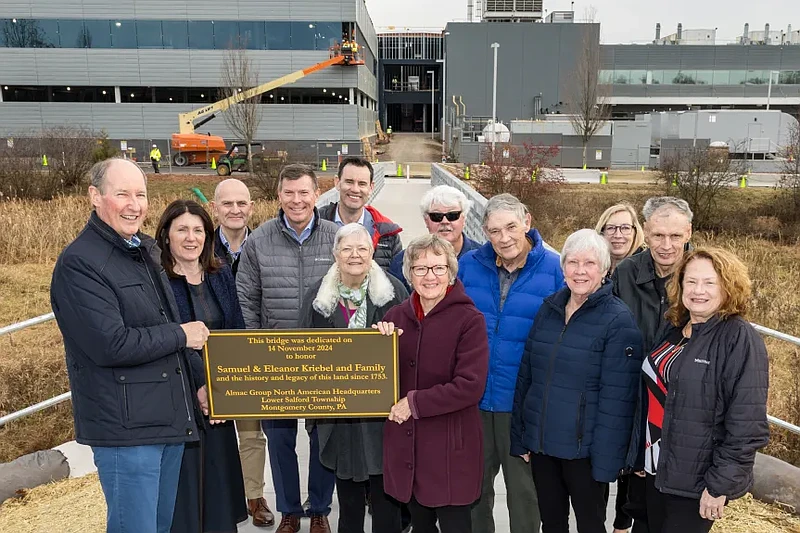 Almac Group executives and local leadership dedicate the company’s new pedestrian bridge to the Kriebel family, the early owners of the land dating back to 1753.(Credit: Almac Group)