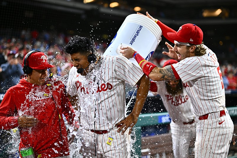 Apr 16, 2024; Philadelphia, Pennsylvania, USA; Philadelphia Phillies starting pitcher Ranger Suarez (55) is showered by second baseman Bryson Stott (5) and outfielder Brandon Marsh (16) after pitching a complete game shutout against the Colorado Rockies at Citizens Bank Park. Mandatory Credit: Kyle Ross-USA TODAY Sports