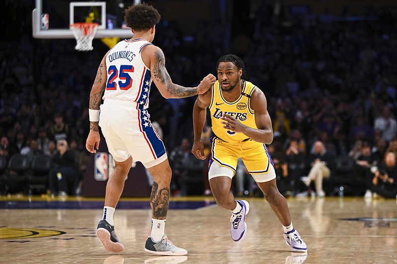 Nov 8, 2024; Los Angeles, California, USA; Los Angeles Lakers guard Bronny James (9) runs past Philadelphia 76ers guard Lester Quinones (25) during the second half at Crypto.com Arena. Mandatory Credit: Jonathan Hui-Imagn Images