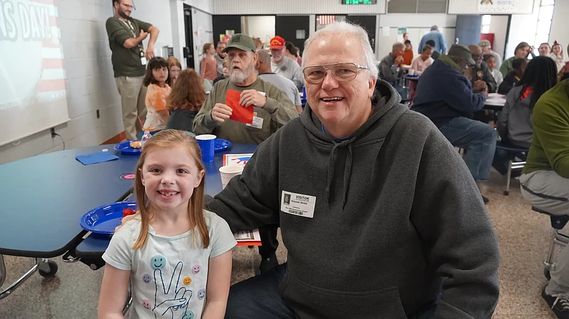 Vincent Orsinis, U.S. Marine Corps veteran, enjoyed breakfast with his granddaughter, Avery, a second grader at Blair Mill Elementary School. (Image courtesy The Communication Solutions Group)