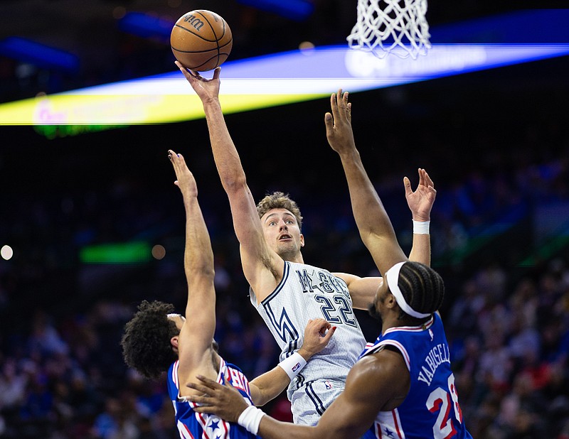 Dec 4, 2024; Philadelphia, Pennsylvania, USA; Orlando Magic forward Franz Wagner (22) shoots between Philadelphia 76ers forward Guerschon Yabusele (28) and guard Jared McCain (20) during the first quarter at Wells Fargo Center. Mandatory Credit: Bill Streicher-Imagn Images