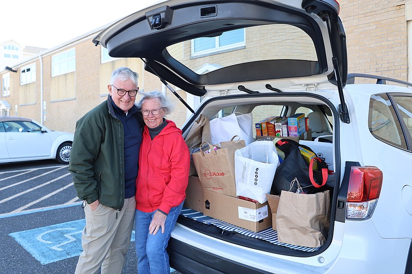 St. Joseph Catholic Church food drive organizers Bill and Bette Keller fill up their SUV with donations.