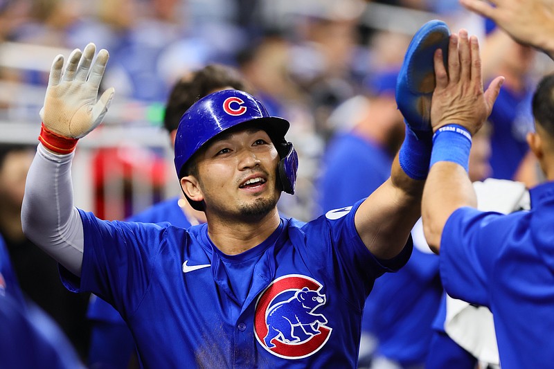 Aug 23, 2024; Miami, Florida, USA; Chicago Cubs designated hitter Seiya Suzuki (27) celebrates with teammates after scoring against the Miami Marlins during the eighth inning at loanDepot Park. Mandatory Credit: Sam Navarro-USA TODAY Sports