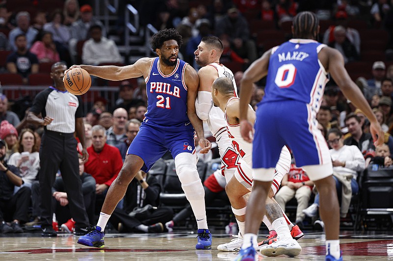 Dec 8, 2024; Chicago, Illinois, USA; Chicago Bulls center Nikola Vucevic (9) defends against Philadelphia 76ers center Joel Embiid (21) during the first half at United Center. Mandatory Credit: Kamil Krzaczynski-Imagn Images