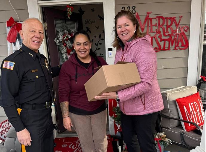 Atlantic County Sheriff Joe O'Donoghue and Assemblywoman Claire Swift deliver a holiday meal to a resident at Pleasantville's Woodlands.