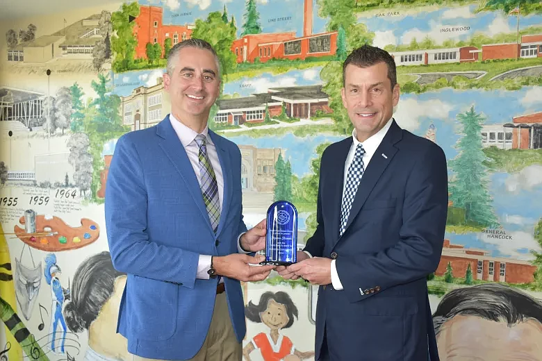 North Penn Superintendent Todd Bauer, left, presents district CFO Steve Skrocki with a "Four E's" employee recognition award. (Credit: North Penn School District)