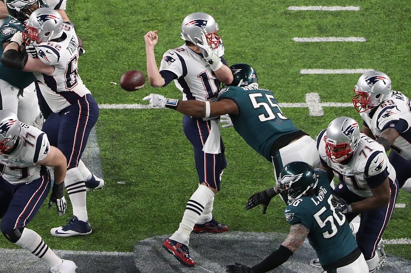 Feb 4, 2018; Minneapolis, MN, USA; New England Patriots quarterback Tom Brady (12) fumbles the ball as he is hit by Philadelphia Eagles defensive end Brandon Graham (55) during the fourth quarter in Super Bowl LII at U.S. Bank Stadium. Mandatory Credit: Kevin Jairaj-USA TODAY Sports