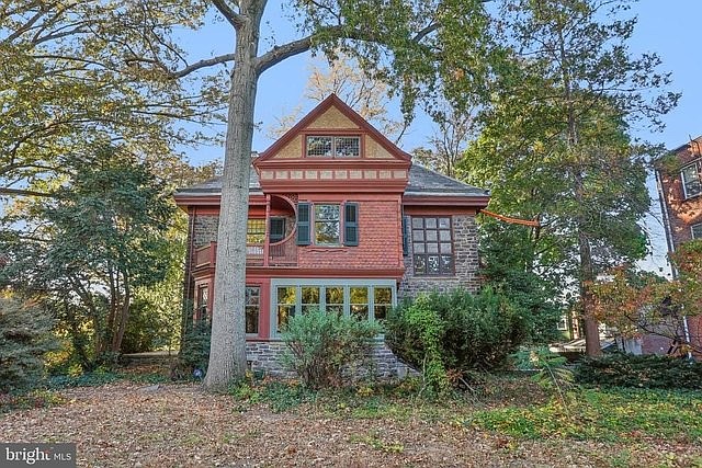 51 E Penn Street: This 1900 Victorian Germantown home, designed by George T. Pearson, features original stained-glass windows, intricate woodwork, and a private wooded lot.