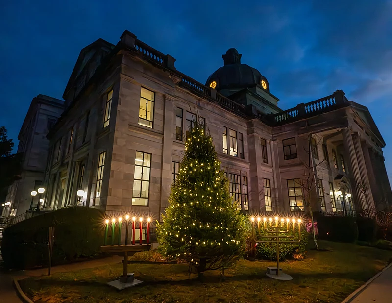 A Kinara, Christmas tree and Menorah are lit on Dec. 9, 2024, outside the Montgomery County Courthouse in downtown Norristown. (Credit: Montgomery County PA)