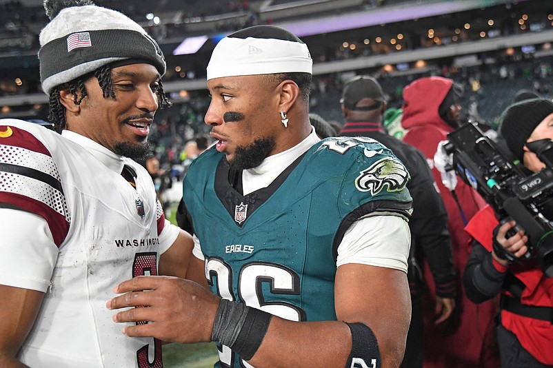 Nov 14, 2024; Philadelphia, Pennsylvania, USA; Washington Commanders quarterback Jayden Daniels (5) and Philadelphia Eagles running back Saquon Barkley (26) meet on the field after the game at Lincoln Financial Field. Mandatory Credit: Eric Hartline-Imagn Images