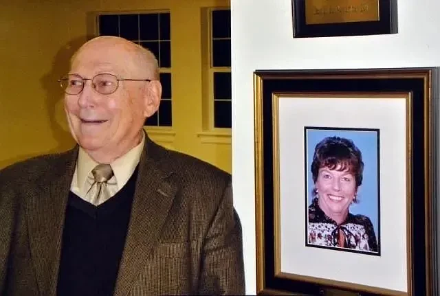 Herb Kavash stands in front of a photo of his wife, Molly, who died in May 2011. (Submitted photo)