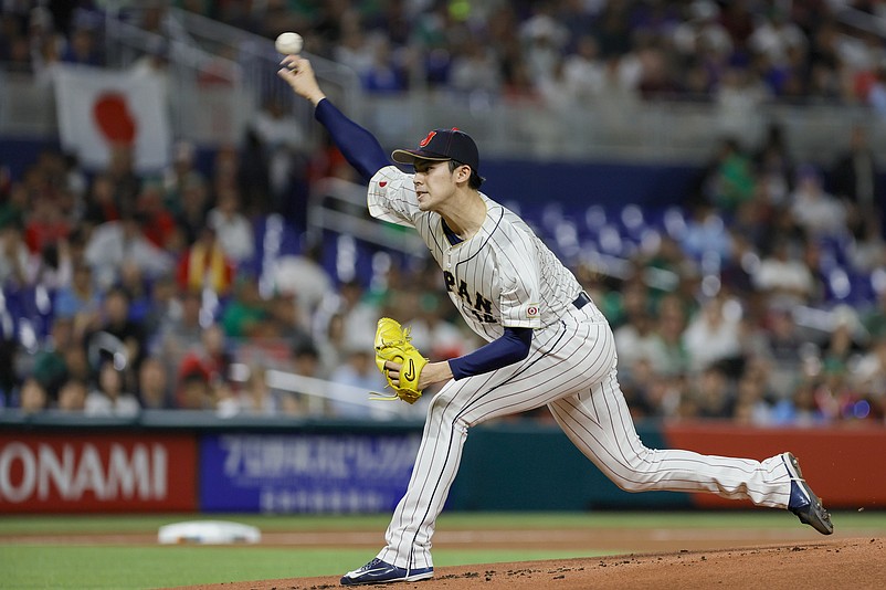 Mar 20, 2023; Miami, Florida, USA; Japan starting pitcher Roki Sasaki (14) delivers a pitch during the first inning against Mexico at LoanDepot Park. Mandatory Credit: Sam Navarro-USA TODAY Sports