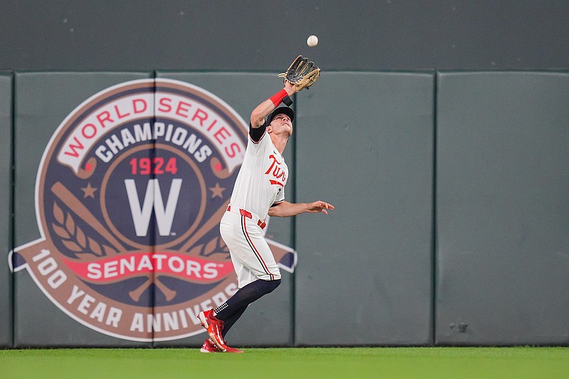 Aug 27, 2024; Minneapolis, Minnesota, USA; Minnesota Twins outfielder Max Kepler (26) fields a fly ball against the Atlanta Braves in the eighth inning at Target Field. Mandatory Credit: Brad Rempel-USA TODAY Sports