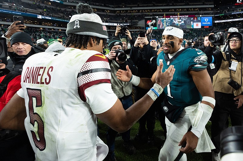 Nov 14, 2024; Philadelphia, Pennsylvania, USA; Philadelphia Eagles quarterback Jalen Hurts (1) and Washington Commanders quarterback Jayden Daniels (5) shake hands after an Eagles victory at Lincoln Financial Field. Mandatory Credit: Bill Streicher-Imagn Images