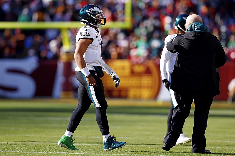 Dec 22, 2024; Landover, Maryland, USA; Philadelphia Eagles quarterback Jalen Hurts (1) walks off the field to leave the game during the first quarter against the Washington Commanders at Northwest Stadium. Mandatory Credit: Peter Casey-Imagn Images