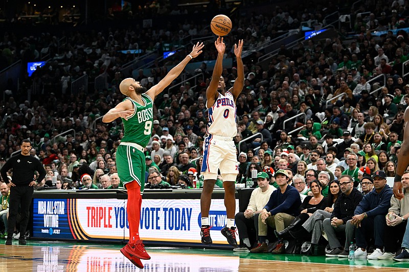 Dec 25, 2024; Boston, Massachusetts, USA; Philadelphia 76ers guard Tyrese Maxey (0) shoots over Boston Celtics guard Derrick White (9) during the first half at TD Garden. Mandatory Credit: Eric Canha-Imagn Images